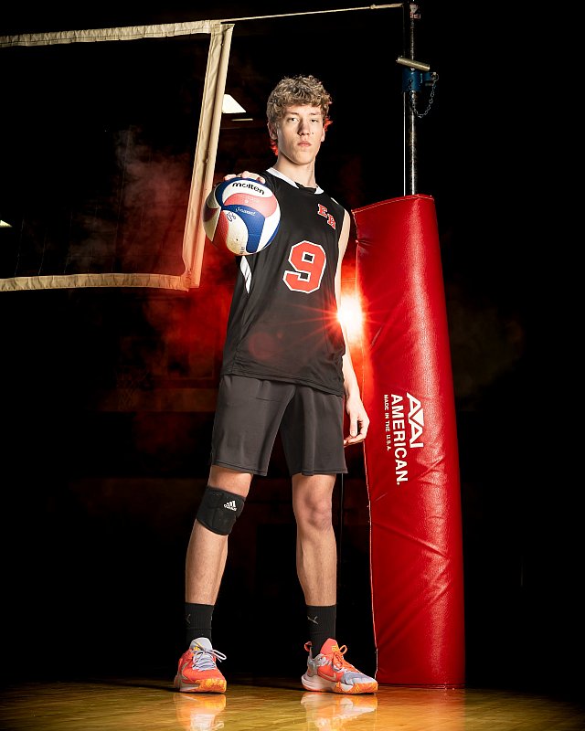 boy volleyball player poses for picture day elk river, mn